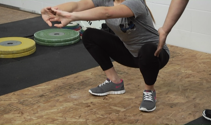 Woman in a low squat position