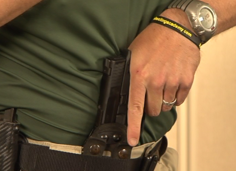 Man with a gun in a waist band
