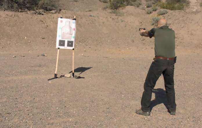 Man shooting at a target outside