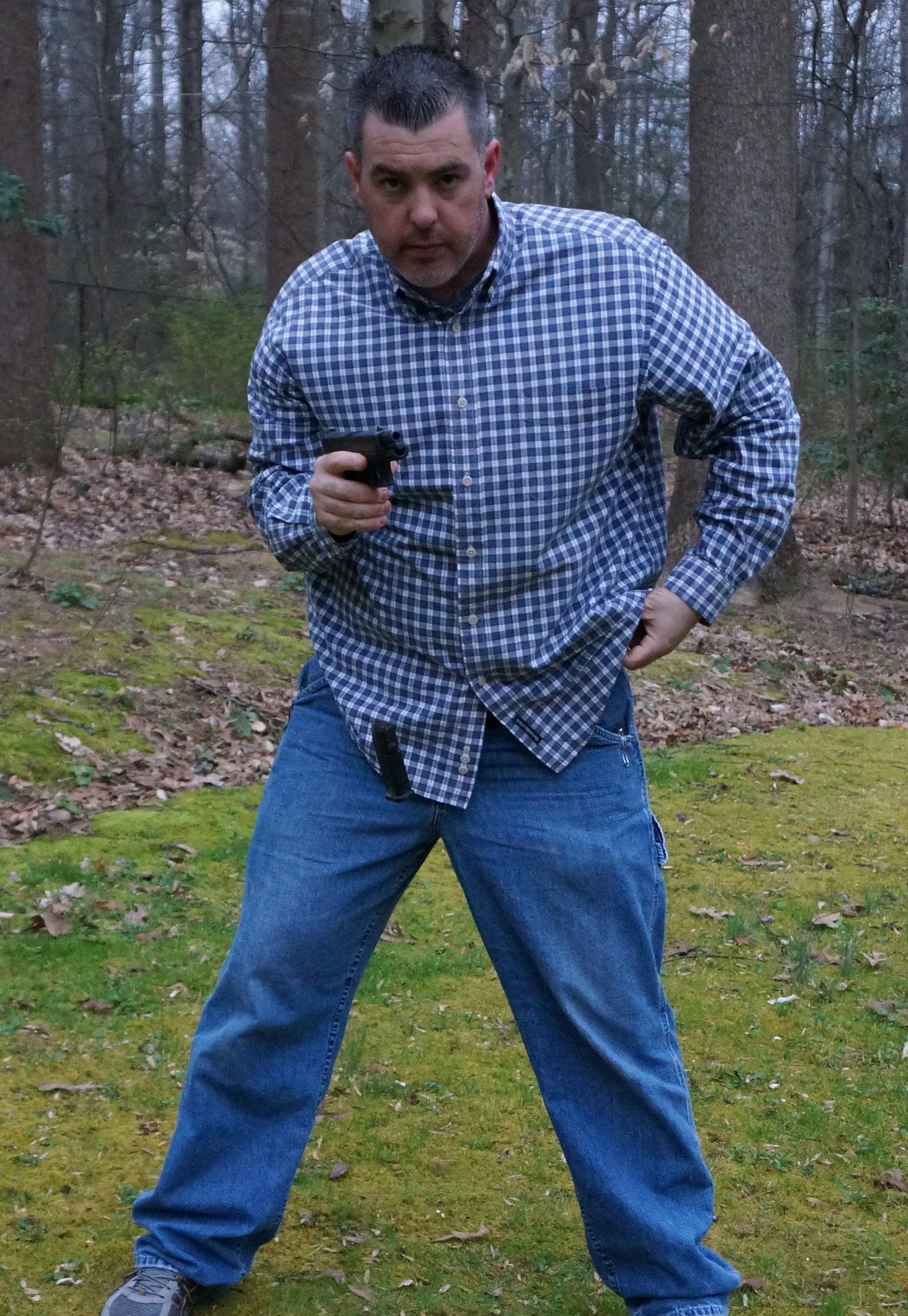 Author responds to stimulus of slide locking to the rear and has simultaneously brought gun back into high compressed work area, ejected magazine, and is reaching for a full magazine carried horizontally on his belt.  