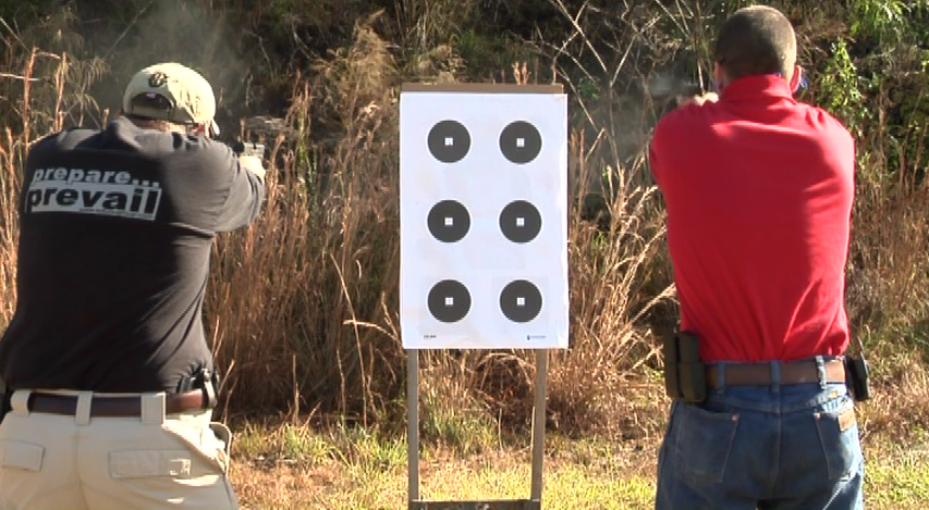 Two men at an outdoor range with target practice