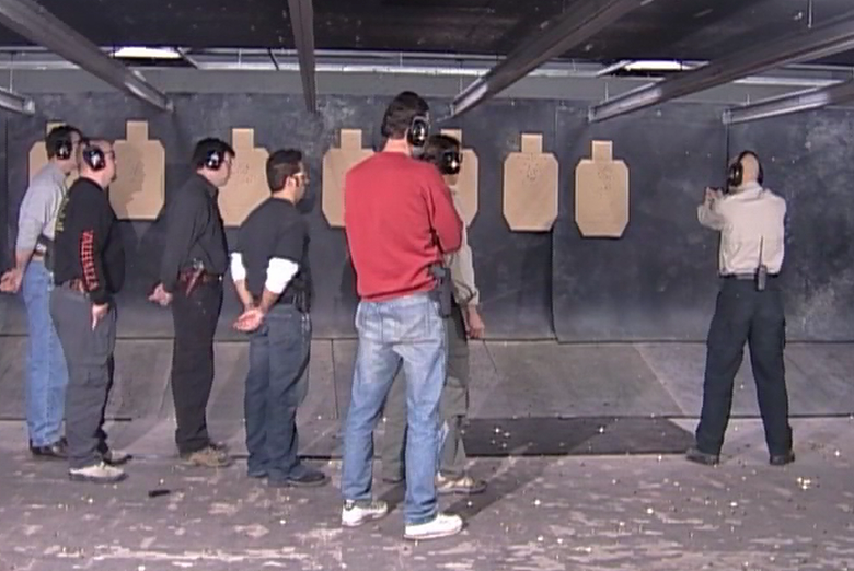 Man at an indoor shooting range