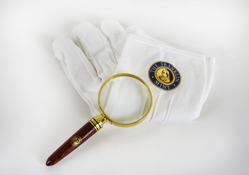 White gloves and a magnifying glass