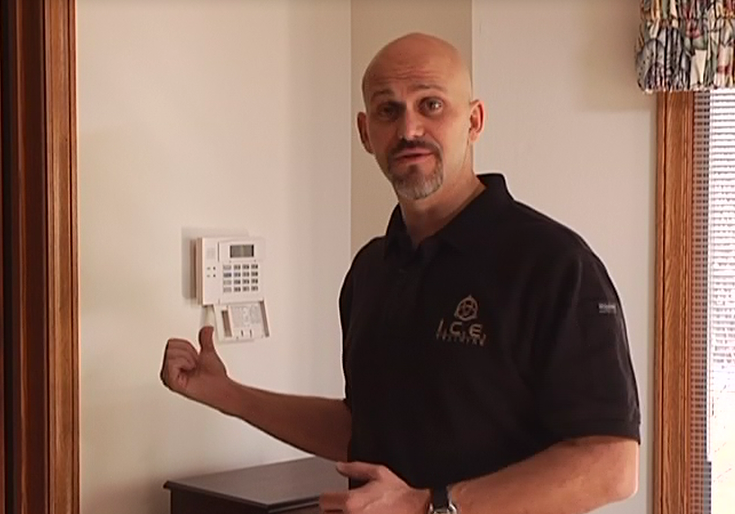 Man pointing to a home security system