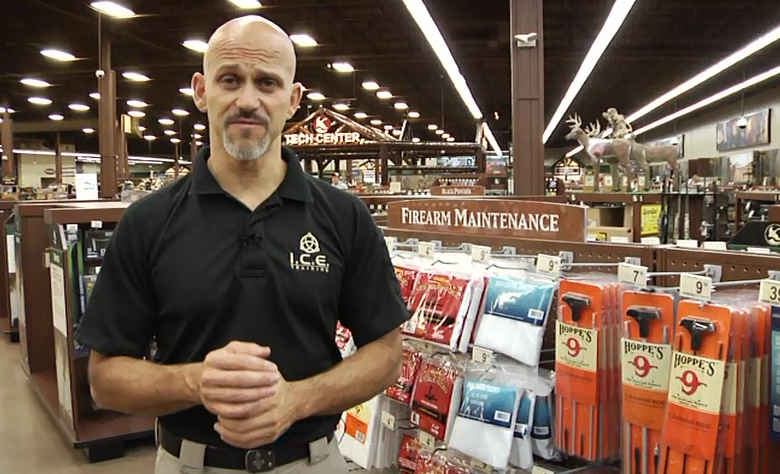 Man in front of firearm maintenance display