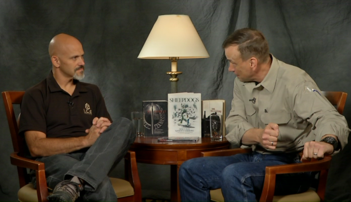 Two men sitting in chairs talking