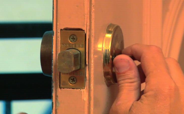 Hand on a deadbolt