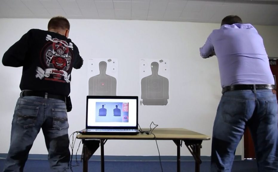 Two men practicing with targets indoors