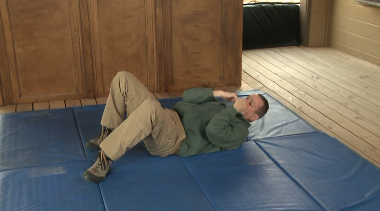 Man in a defensive position on the ground