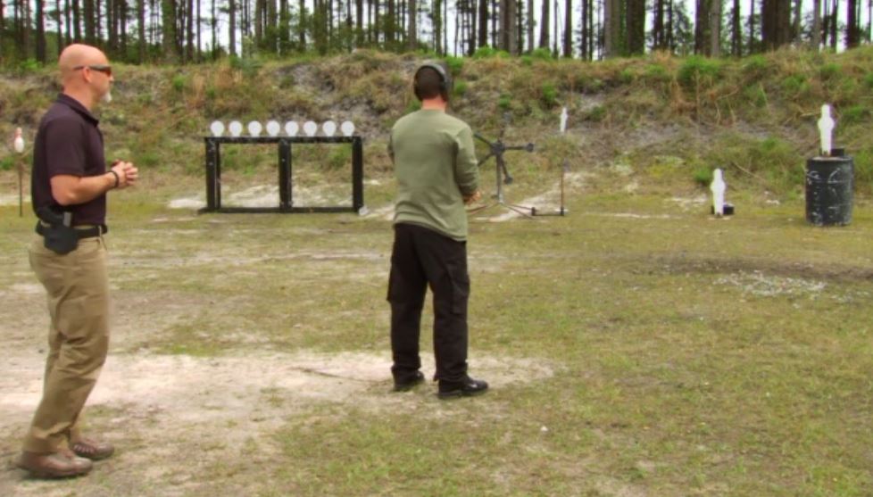 Man doing target practice with a steel target