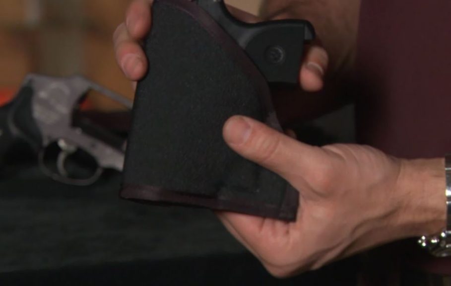 Person holding a gun in a holder