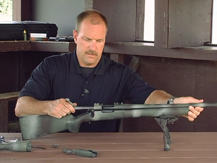 Man putting together a rifle