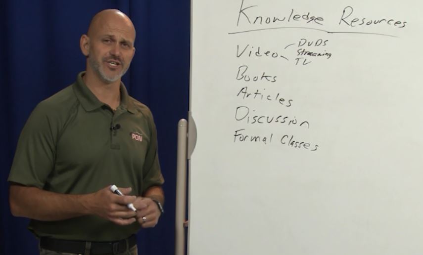 Man writing on a whiteboard about where to get knowledge resources