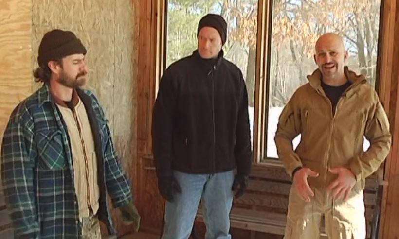 Three men talking outside
