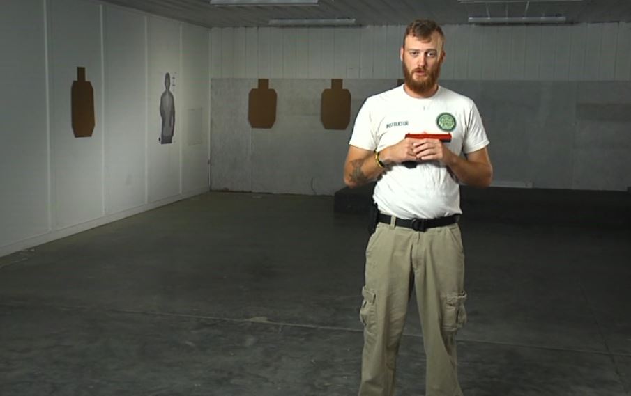 Man holding a red pistol