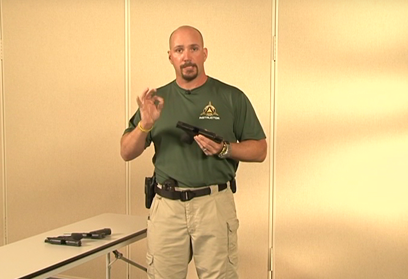 Man holding a gun and talking