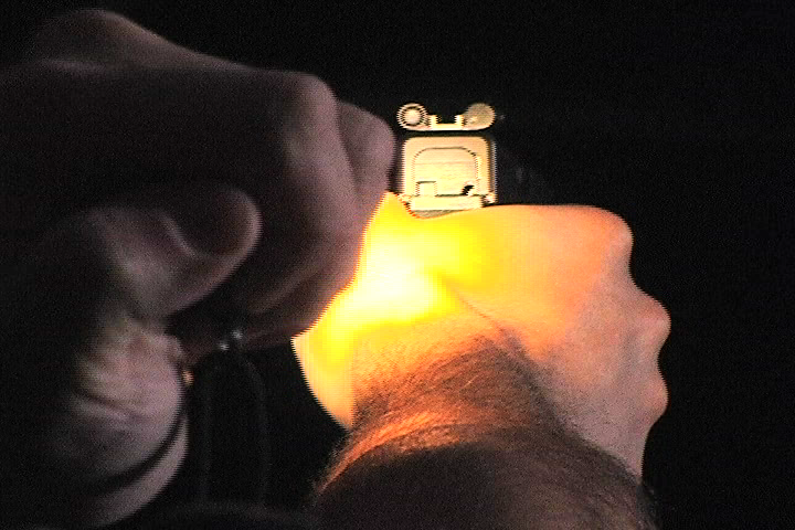 Person using a flashlight while aiming a gun