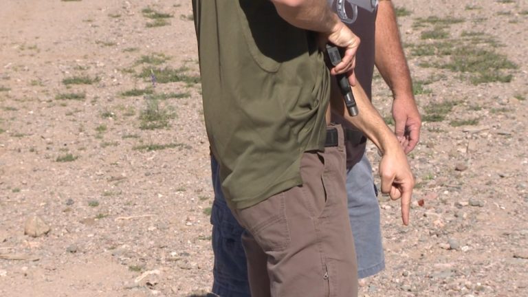 Man holding a gun pointing down