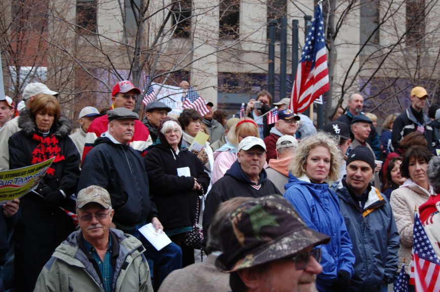 People at a rally with American flags