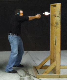 Man with ear protection shooting a gun