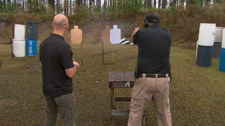 Two men outside at a shooting range