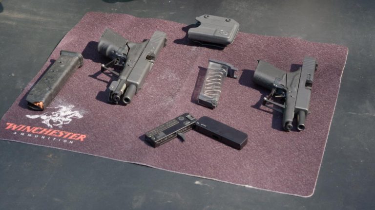 Folding pistols laying on a mat