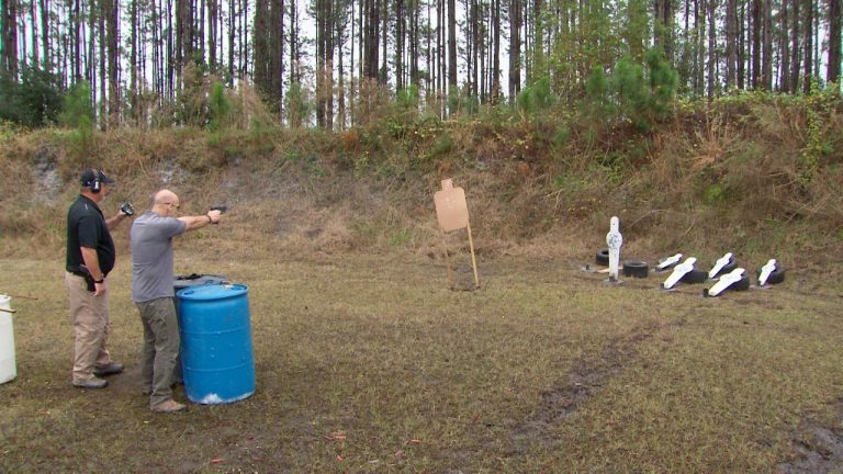 Two men outside doing target practice