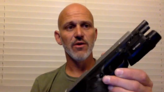 Screenshot of a man with a gun