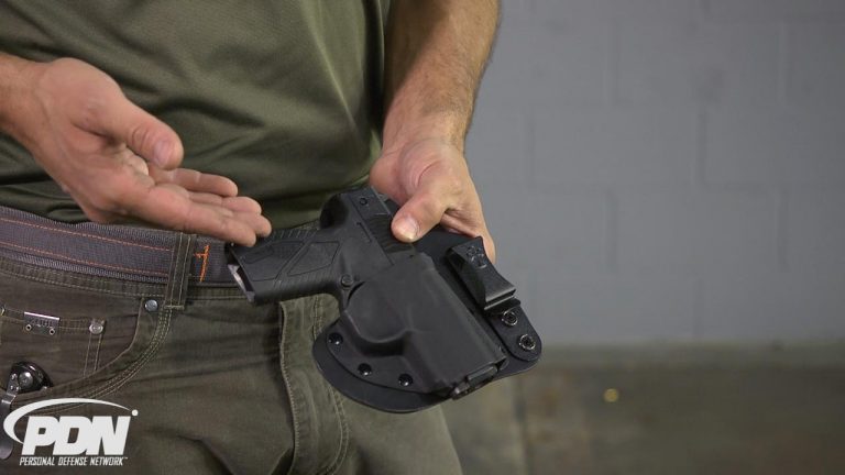 Person holding a gun in a holster