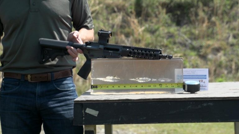 Man holding a pistol length AR barrel