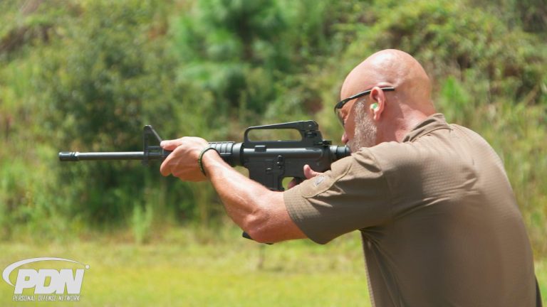 Man aiming a defensive rifle