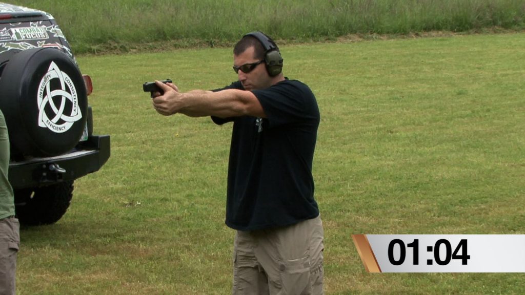Man wearing protective ear wear holding a gun