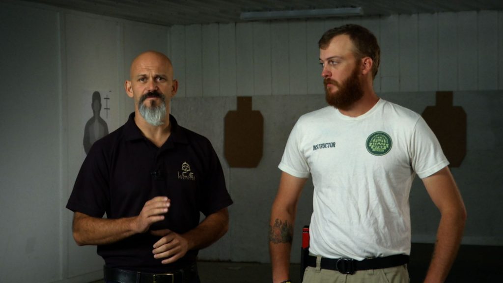 Two man talking at an indoor range