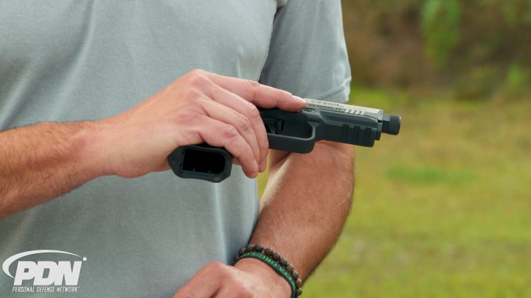 Man holding a gun sideways