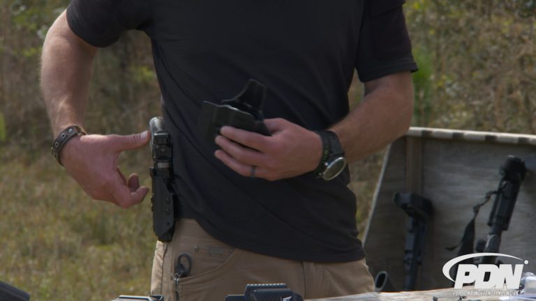 Man reaching for a gun in a holster