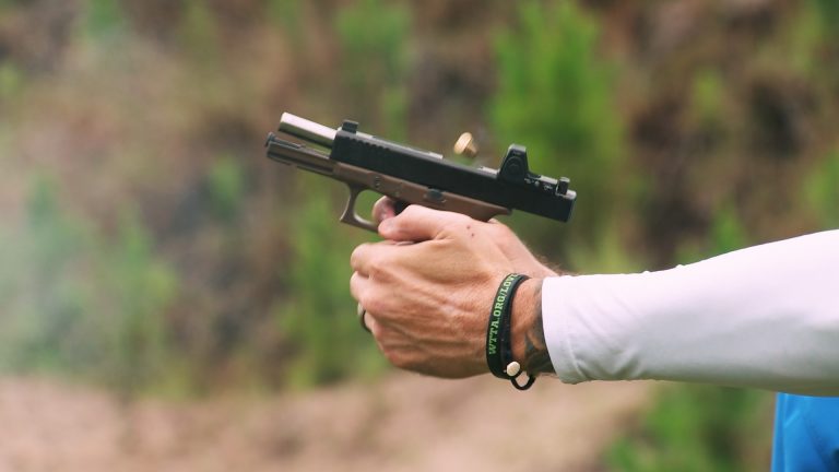 Person holding a handgun during recoil