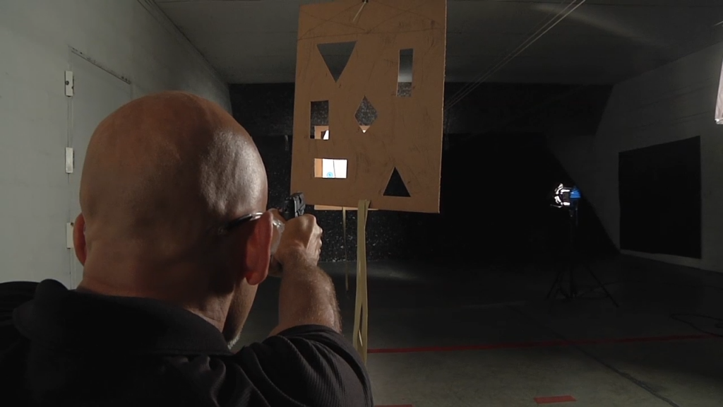 Man aiming a handgun at shape targets