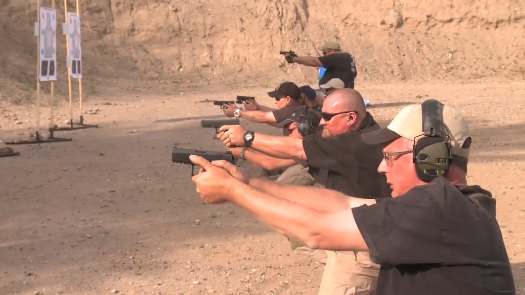 Men outside doing a pistol shooting drill