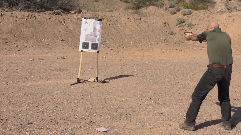 Man aiming a pistol at a target