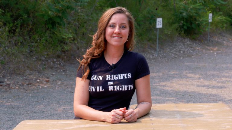 Woman outside with a gun rights shirt on