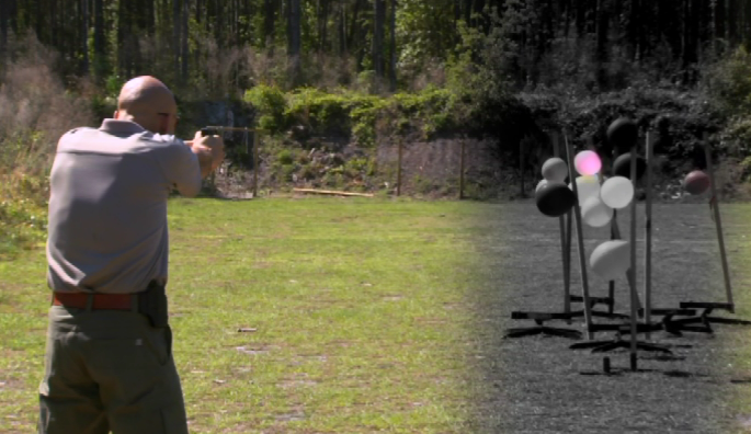 Man practicing shooting a gun with balloon targets