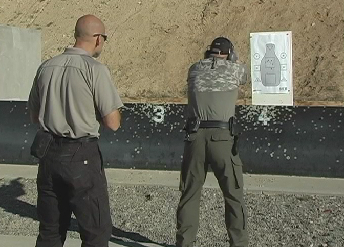 Two men outside doing target practice