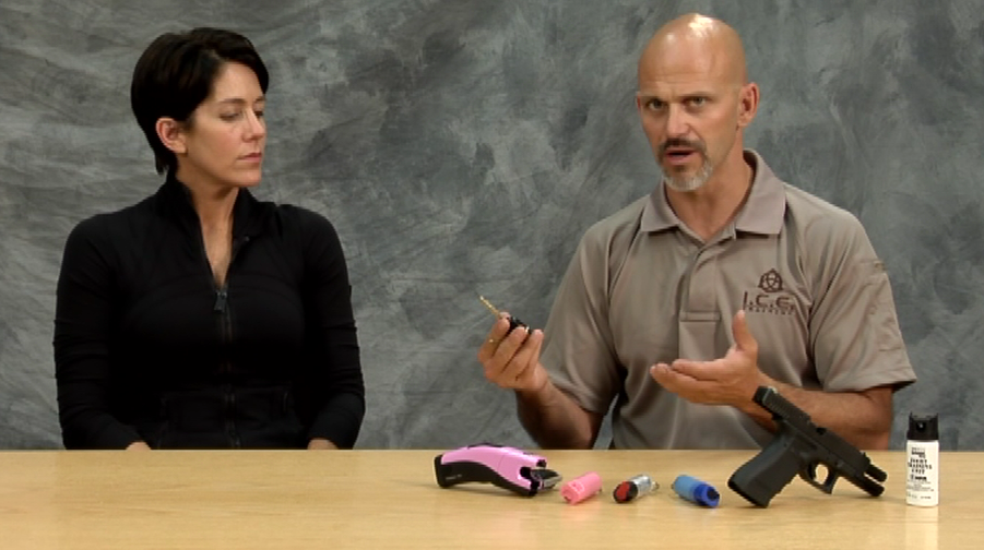 Man and woman with home defense items for women on a table