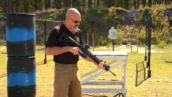 Man with an AR 15 outside