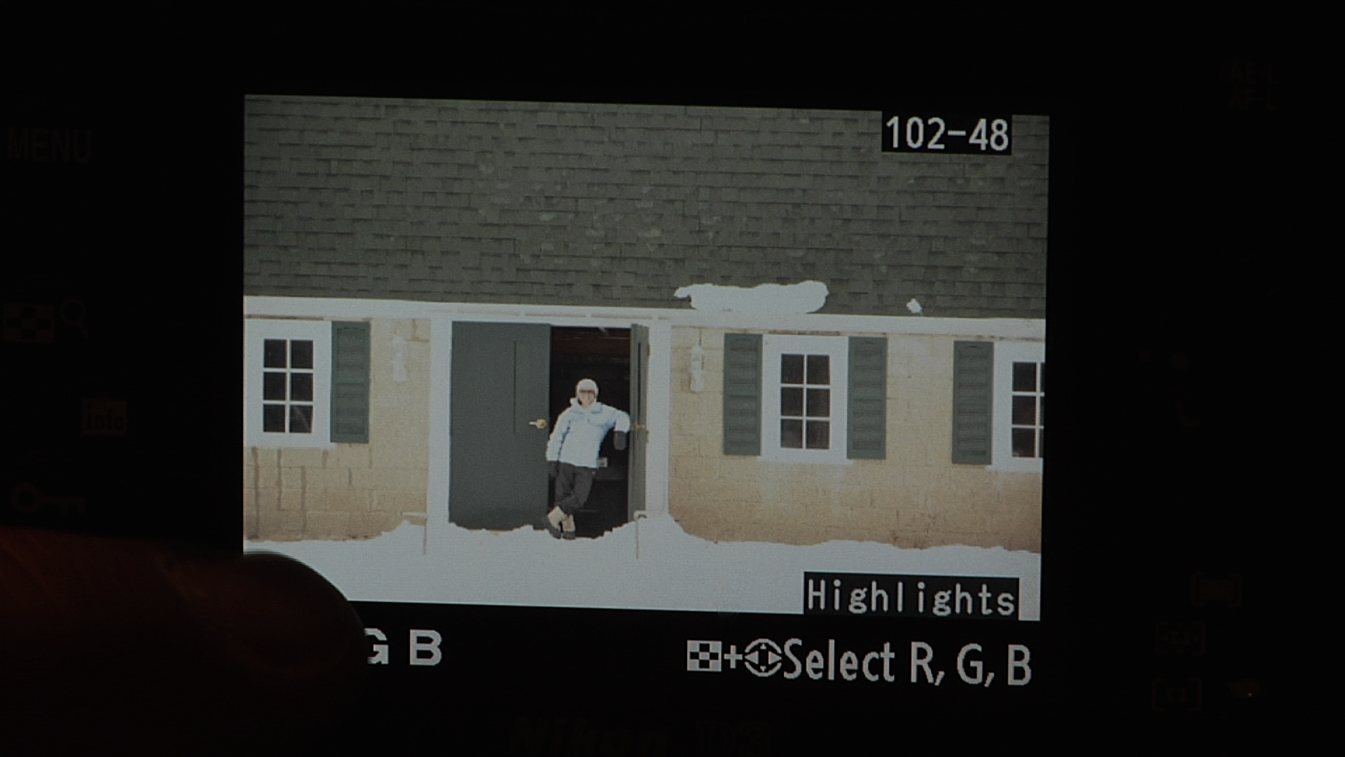 Person in the doorway of a house