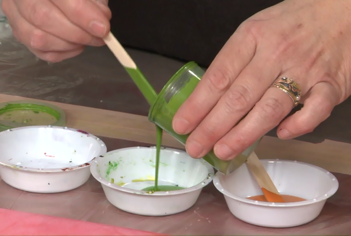 Pouring green paint into a bowl