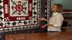 Woman with a hanging wall quilt