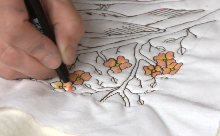 Coloring a quilted flower on white fabric