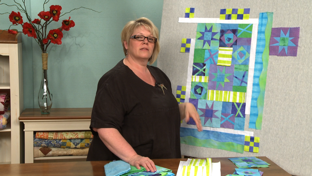 Woman piecing a quilt together
