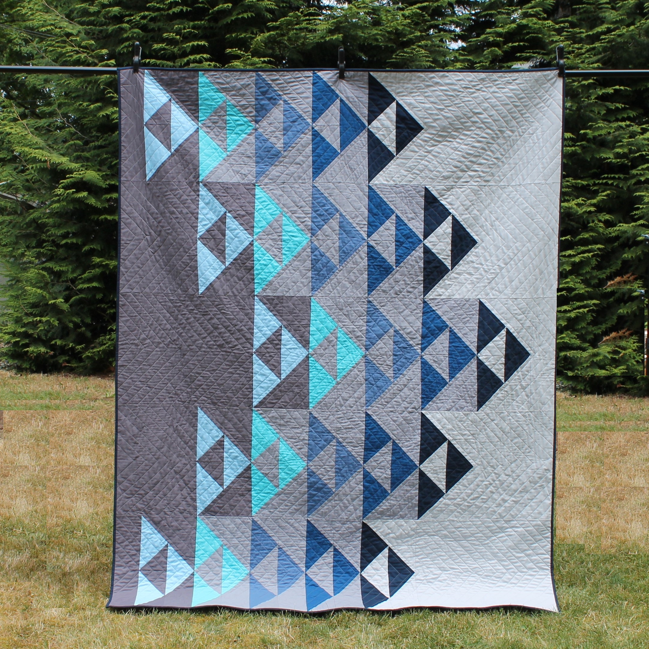 Grey quilt hanging up